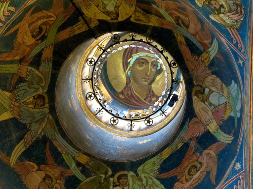 A figure is depicted inside each of the domes.