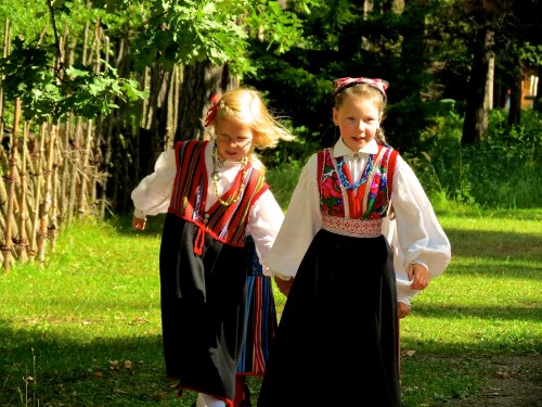 Costumed children running down a path in Rocca al Mare.
