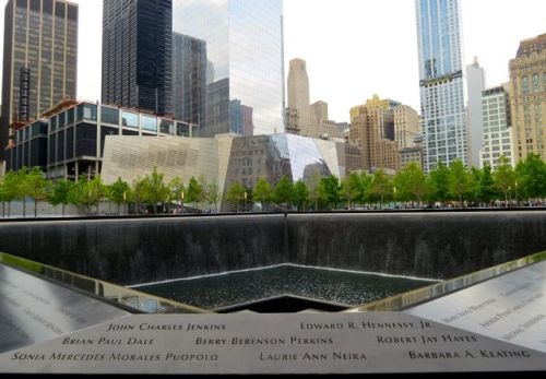 The National September 11 Museum stands watch near one of the Memorial Pools.