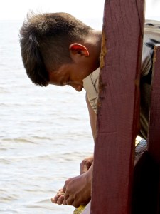 This young boy contributes to his family's income by giving visitors back massages.