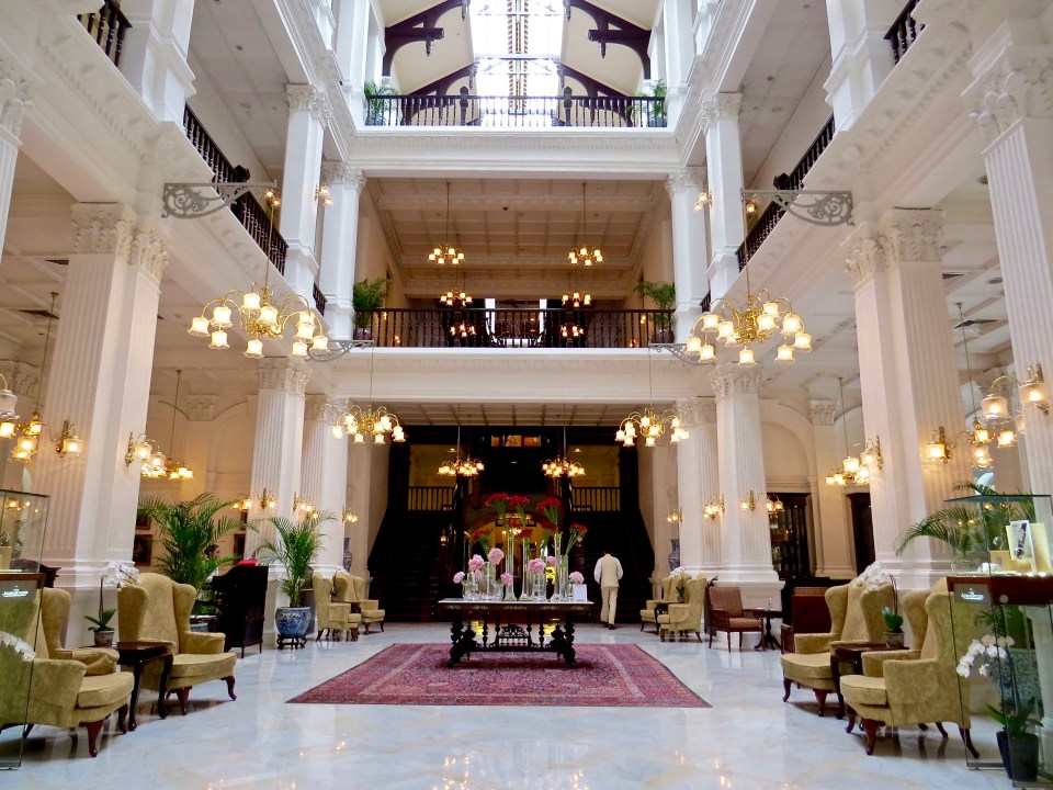 The stunning lobby of the Raffles Singapore Hotel.