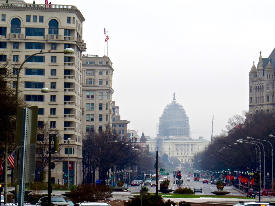 in the distance, the United States Capitol Building under renovation.