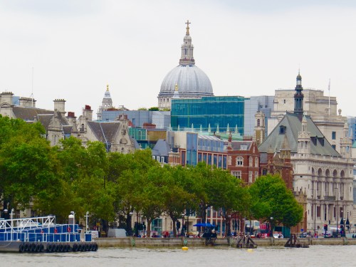 St. Paul's Cathedral towers above the London skyline along the Thames River.
