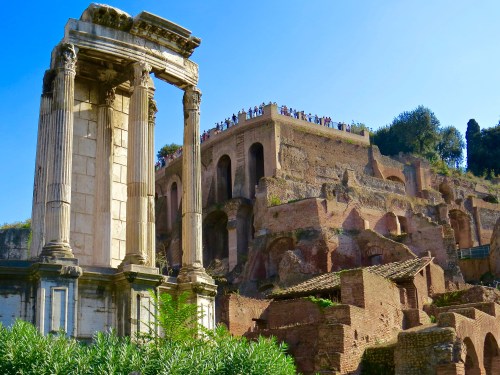 Walking through the Roman Forum with Palatine Hill in the background.